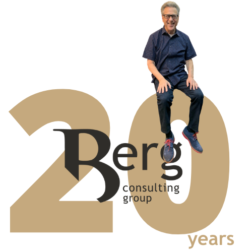 Bruce Berg sitting on top of 20 year Berg Consulting Group Logo